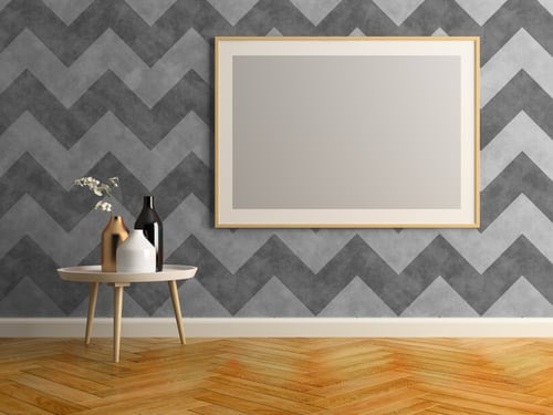 Grey chevron wallpaper feature wall with a framed mirror and herringbone wood floor installed by AR Interiors Decoration Inc