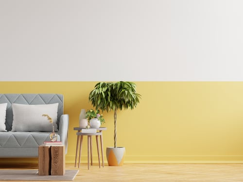 Two-tone interior wall painted in warm yellow and white with a light wood floor, painted by AR Interiors Decoration Inc