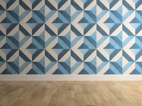 Geometric blue and cream wallpaper installed across a full wall above a light wood floor by AR Interiors Decoration Inc